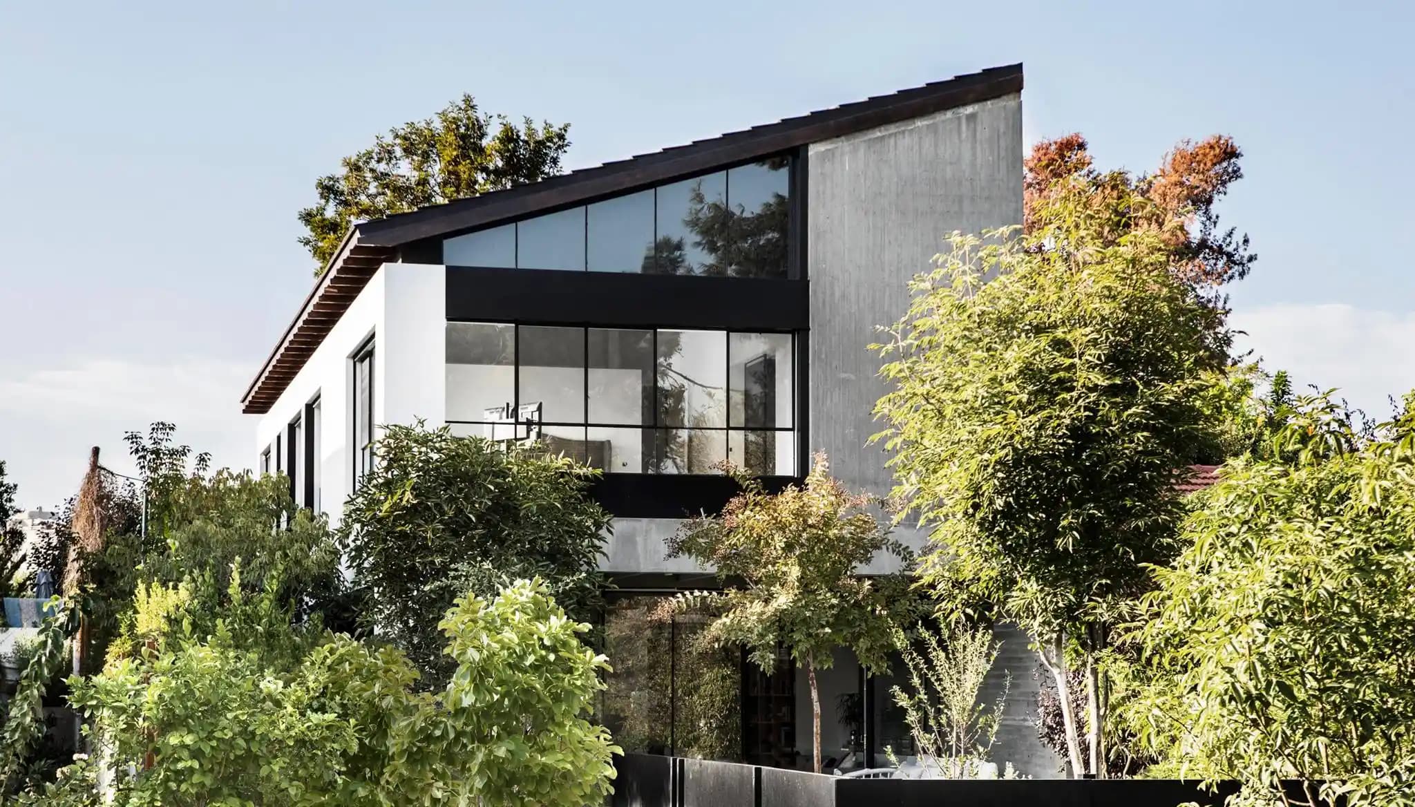 בית פרטי מודרני עם חזית זכוכית גדולה וחיפוי בטון - אדריכלות עכשווית